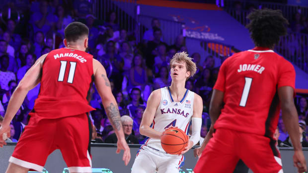 Nov 23, 2022; Paradise Island, BAHAMAS; Kansas Jayhawks guard Gradey Dick (4) shoots as North Carolina State Wolfpack forward Dusan Mahorcic (11) defends during the first half at Imperial Arena.